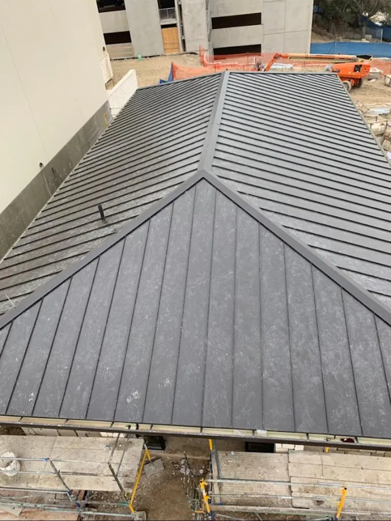 Commercial metal roof construction with crane equipment in Pekin
