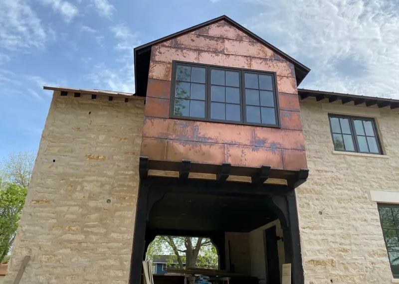 Copper metal panel facade on a stone building for Skylight Installation in Pekin